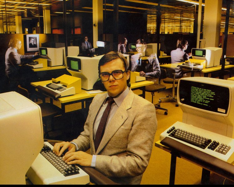 man with holographic images of himself at old computers