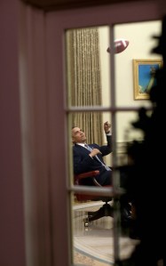 Barack Obama tossing a football in his office