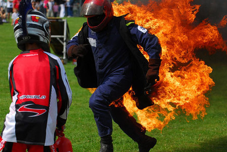 man with fire behind him