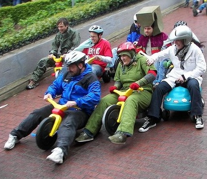 guys racing tricycles