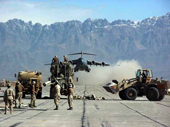 plane approaching runway with people on it